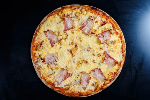 Chicken breasts with creamy sauce and grated cheese on a pizza. tasty fresh pizza on a thick crust with meat