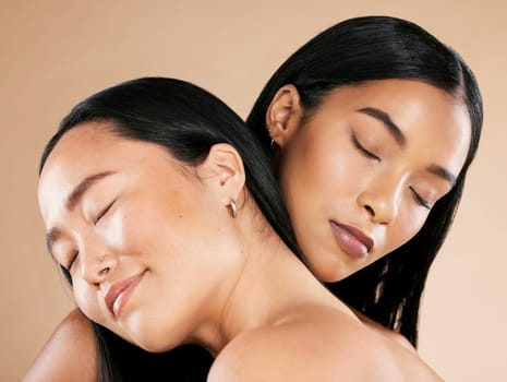 Women, hug and skincare with cosmetics, dermatology and natural beauty on brown studio background. Females, ladies or makeup for confidence, embrace and wellness with support, happiness and soft skin.