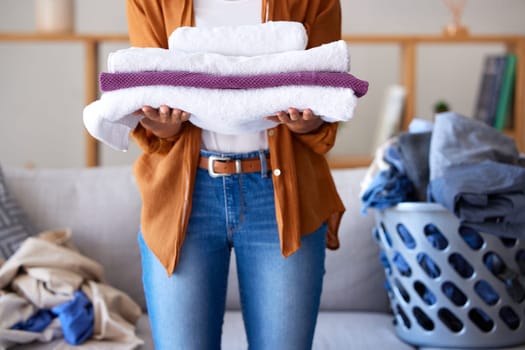 Laundry, towel and texture with cleaning service and woman cleaner, hygiene and disinfection for housekeeping. Spring cleaning, clean fabric and housekeeper with fresh textile, washing and house work