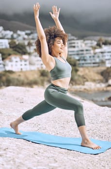 Woman, stretching or yoga mat on beach rock in relax workout, exercise or fitness for body wellness or mental health peace. Smile, happy or zen afro yogi in pilates training by Brazilian nature ocean