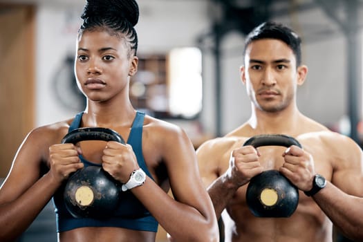 Fitness, kettlebell or couple of friends at gym strength training, exercise or workout at gym together. Team partnership, teamwork or healthy sports athletes with power, motivation or focus at gym.