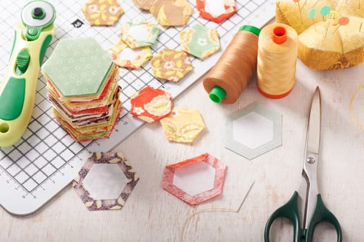 English paper pieced hexagons on white craft mat