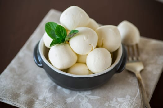 Small balls of traditional mozzarella in a ceramic bowl