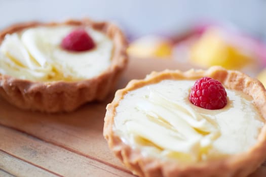 Cream tart closeup, dessert and bakery with cake and sweet treat on wooden table. Pastry, catering and hospitality industry with food, baked goods and custard confectionery, rich snack and fresh bake