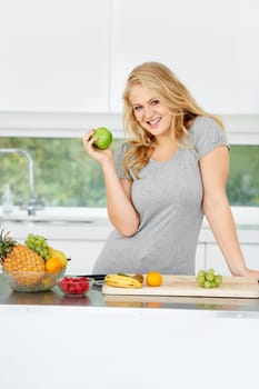 Fruits, apple or portrait of happy girl for healthy lunch or breakfast meal or diet in kitchen at home. Morning snack, smile or vegan woman eating fresh food to lose weight for wellness or gut health.