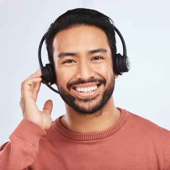 Man with headset, call center and contact us in portrait, smile and communication on studio background. Customer service, telemarketing and tech support with male consultant at help desk job.
