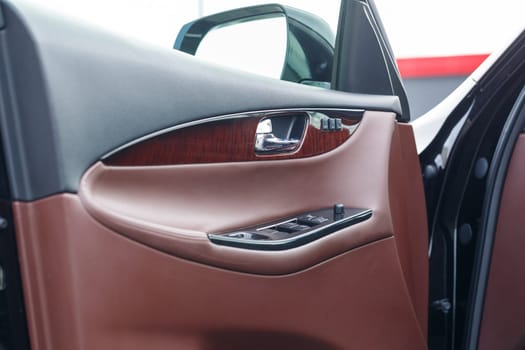 Vehicle interior. Interior trim of car doors. Brown leather car interior.