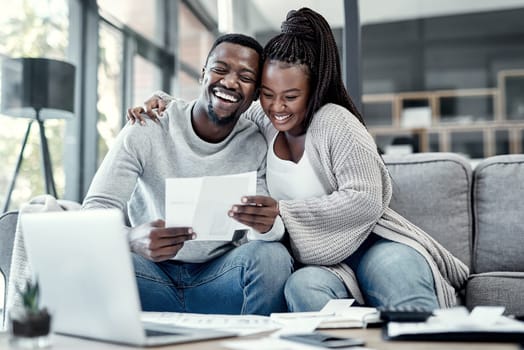 Be debt free, be happy. an affectionate young couple going through paperwork at home.