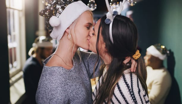 Christmas, kiss and love with lesbian couple at party for celebration, festive and holiday. Lgbtq, gay and dance with women partners at xmas event for romance, social and relax at reunion gathering