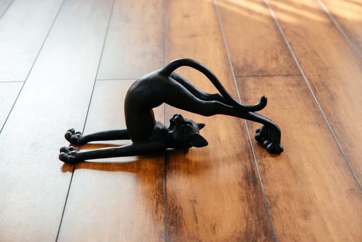 Ceramic black cat figurine bending doing yoga pose
