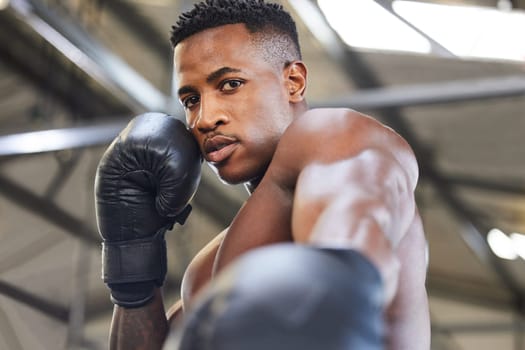 African man, boxing and punch in portrait for fitness, focus or training at gym for growth, goal and competition. African guy, boxer and gloves for exercise, wellness and martial arts club for sports