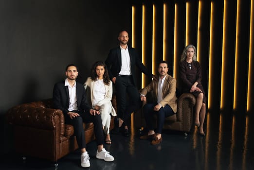 Confident Middle Eastern Business People Sitting In Black Luxury Office