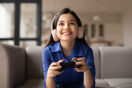 Kid Girl Playing Video Game With Gaming Console At Home