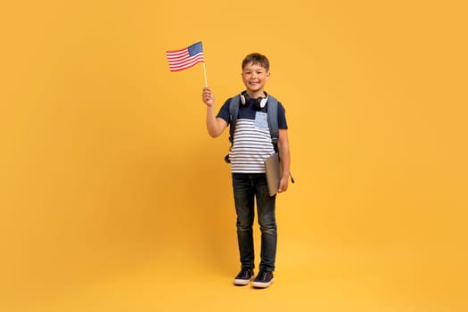 Happy kid school boy showing flag of the US