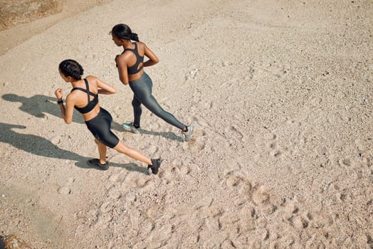 Fitness friends run on the beach, women workout together with cardio and active lifestyle outdoor. Exercise in nature, healthy and top view of female people training with running and mockup space.