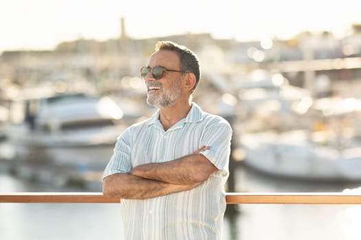 Senior Man Posing Crossing Hands Enjoying Sea Holidays At Marina