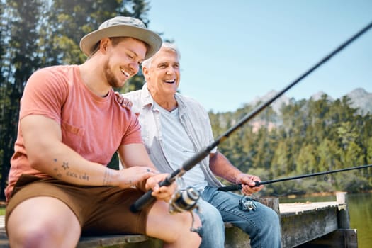 Happy man, father and fishing in lake for fun bonding, hobby or relaxing together in the nature outdoors. Elderly male person laughing with son and enjoying time to catch fish on holiday by forest