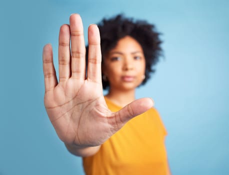 Portrait, stop hand sign and woman in studio isolated on a blue background mockup space. African person, face and ban, rejection or warning, refuse or no palm to protest racism, human rights or emoji