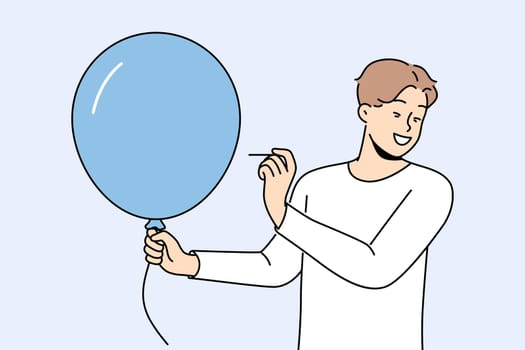 Man with balloon holds needle, wanting to make loud explosion to cheer people around