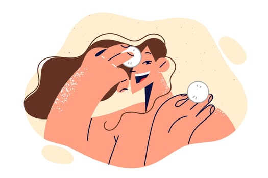 Woman uses cotton pads to treat face and fight wrinkles or remove excess makeup before bed.
