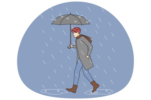 Man with umbrella walking in rain
