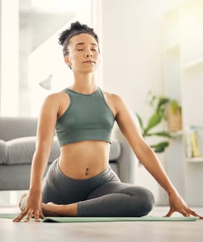 Yoga, breathing and woman doing a stretching exercise for mobility, flexibility and wellness. Health, meditation and young female person doing pilates workout in living room of her home or apartment.