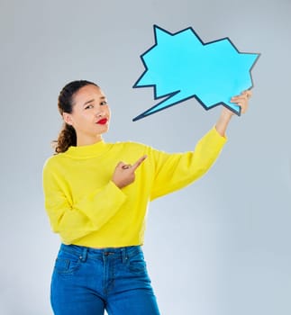Speech bubble, confused and woman pointing to chat, social media opinion and confused for translation in portrait. Gen z person with doubt, question and language mockup or quote on studio background