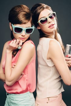 Fashion, beauty and retro with portrait of women in studio for elegant, pastel and vintage. Sunglasses, confident and cosmetics with female model on dark background for glamour, beehive and style