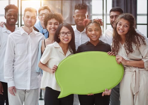 young group of people holding speech bubbles in modern office