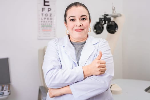 Optometry specialist with thumb up. Smiling eye doctor with thumb up in office, Female optometrist with thumb up in the laboratory
