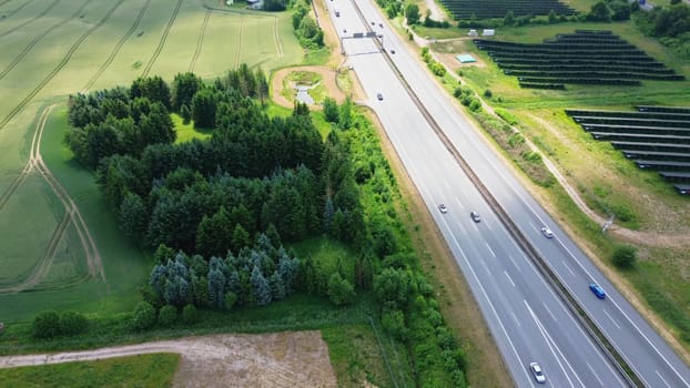 Aerial view of the A7 motorway in northern Germany with big solar panel areas close to the highway.