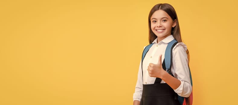 happy teen girl in school uniform carry backpack showing thumb up, copy space, september 1. Banner of schoolgirl student. School child pupil portrait with copy space