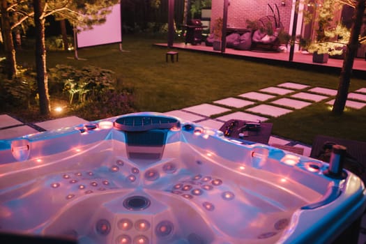 self-contained hot tub or pool with hot water and evening lighting