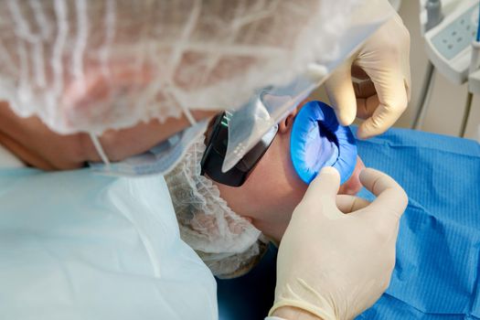 Dentist doing a dental treatment on a patient in medical clinic