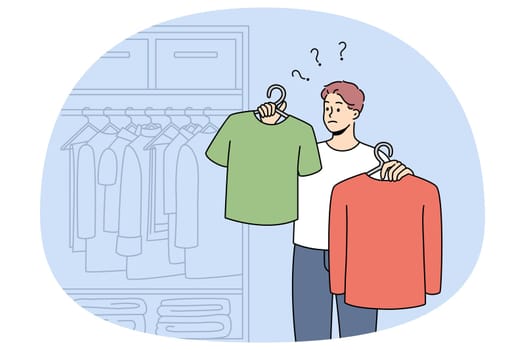 Man choose what to wear in wardrobe