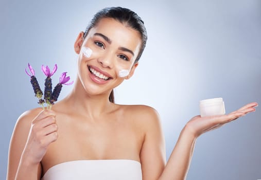 Beauty, cream and woman with lavender flower in studio for skincare product and natural glow. Portrait of happy female model on a gradient background for facial shine, cosmetics and face moisturizer