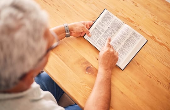 Above, reading book or old man with holy bible for worship, support or hope in Christianity faith in retirement. Jesus, God or senior person studying or learning gospel prayer in spiritual religion