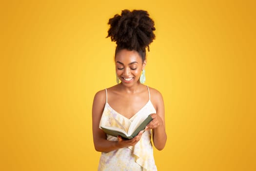 Smiling millennial african american lady reading book, enjoy free time, homework