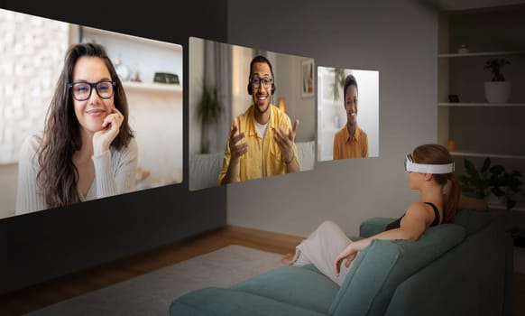 Woman Wearing Virtual Reality Headset Having Video Conference At Home