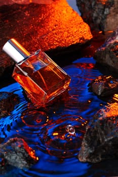 Bottle of perfume on a background of stones