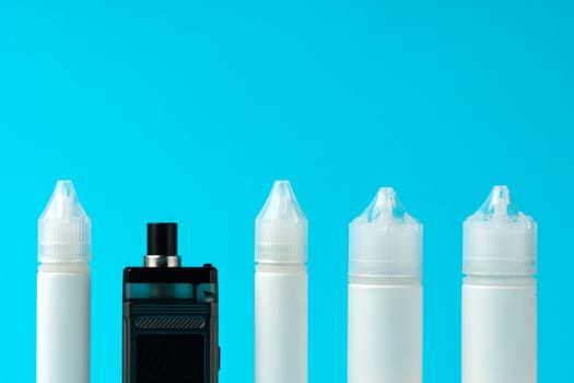 Electronic cigarettes liquid bottles on blue background