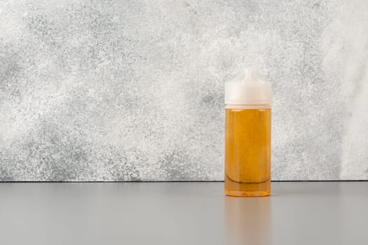 Refill liquid for electronic cigarettes on gray background