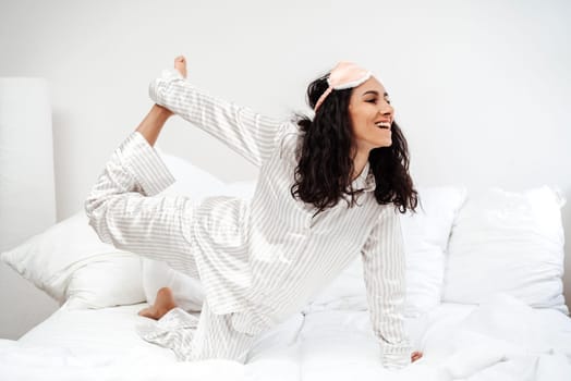 Young woman of Hispanic waking up doing exercises for a healthy lifestyle. The girl easily does yoga pose. The joy of exercise is a charge of positive emotions and energy for the whole day.