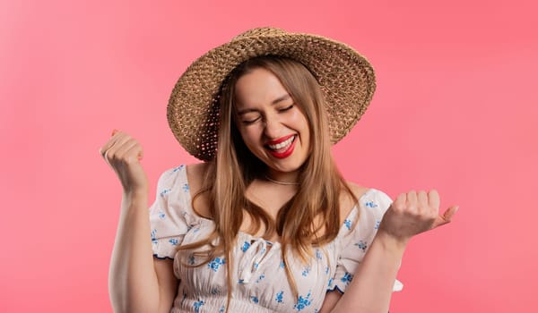 Pretty woman shows triumph yes gesture of victory, she achieved result, goals. Girl glad, happy, surprised excited happy lady on pink background. Jackpot concept. High quality