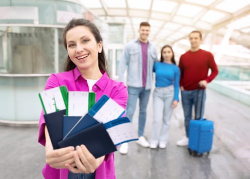 Happy Tourist Woman Showing Tickets Traveling With Friends In Airport