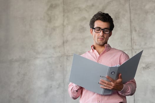 Handsome millennial man director checking marketing report at office