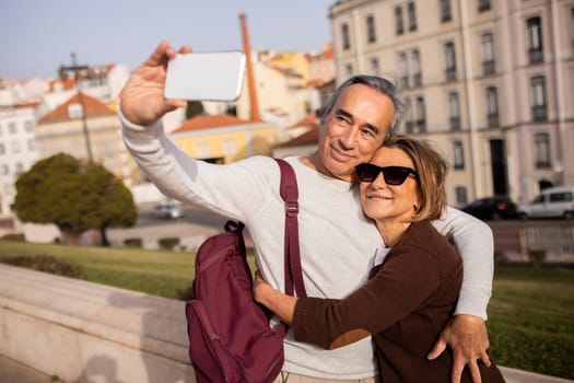 Happy Pensioners Couple With Backpack Making Selfie Using Smartphone Outdoor