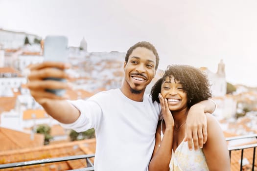 Satisfied young african american guy hug woman with ring, taking selfie of engagement, enjoy date