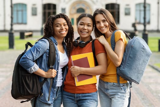 College Friendship Concept. Three Multiethnic Female Students Posing Outdoors At Campus