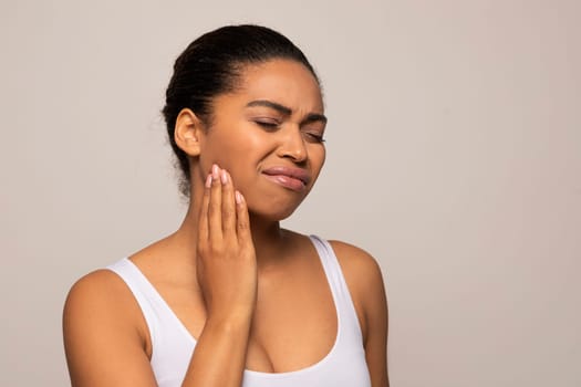 Black woman suffering from strong tooth pain, copy space